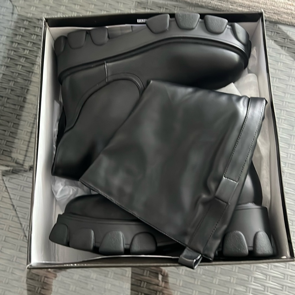 Black cleated knee high pocket boots